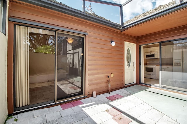 doorway to property featuring a patio area