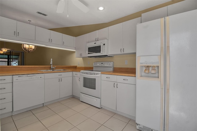 kitchen featuring white appliances, ceiling fan, sink, white cabinets, and light tile patterned flooring