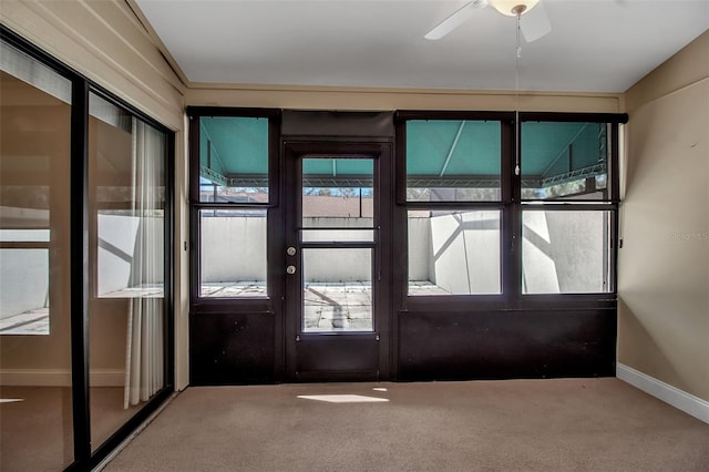 doorway to outside with ceiling fan and carpet floors