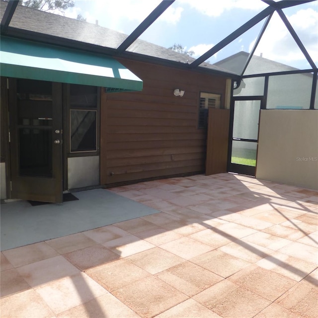 view of patio / terrace featuring glass enclosure