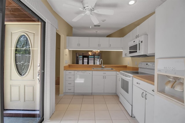 kitchen featuring white appliances, white cabinets, sink, ceiling fan, and light tile patterned flooring