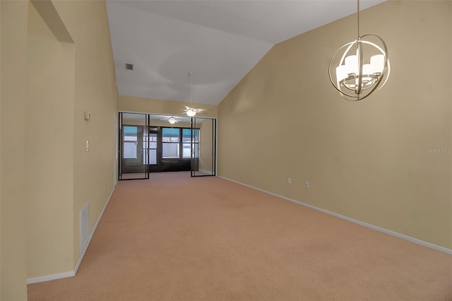 carpeted spare room with vaulted ceiling and an inviting chandelier