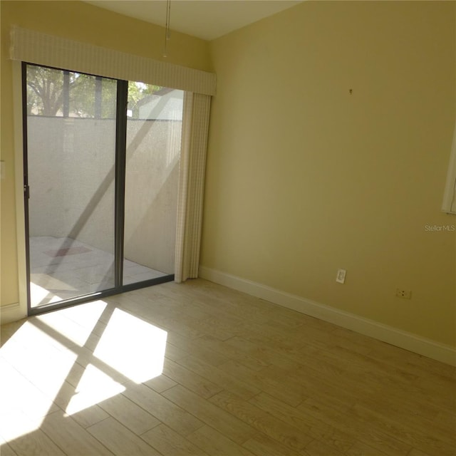 unfurnished room with light hardwood / wood-style floors