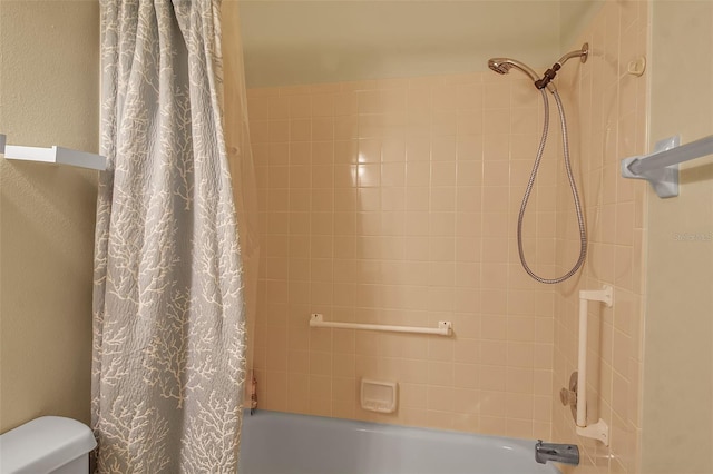 bathroom featuring shower / bathtub combination with curtain and toilet