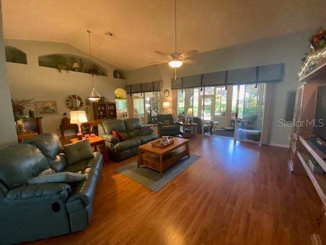 living room featuring ceiling fan, vaulted ceiling, and hardwood / wood-style floors