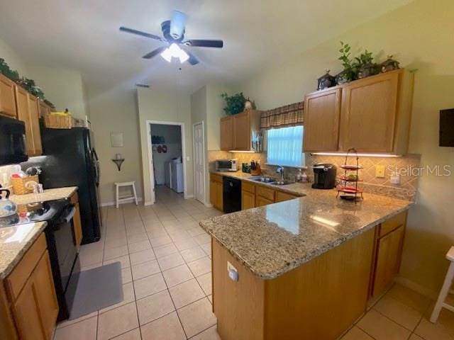 kitchen with kitchen peninsula, sink, black appliances, light tile patterned flooring, and ceiling fan