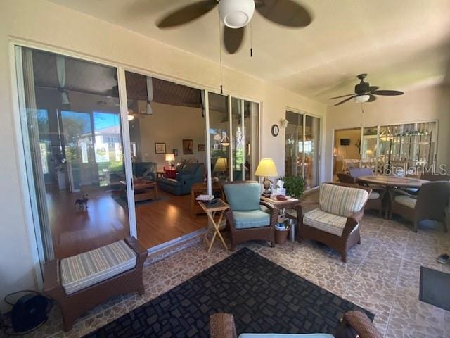 sunroom / solarium featuring ceiling fan and vaulted ceiling