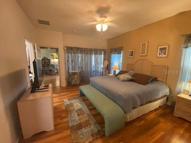 bedroom with wood-type flooring and ceiling fan