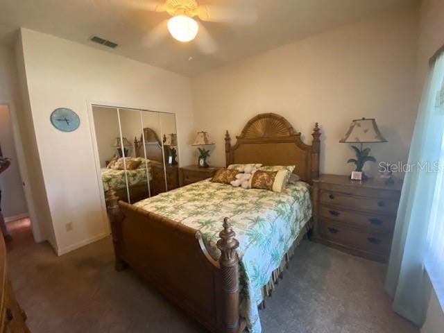 carpeted bedroom featuring a closet and ceiling fan