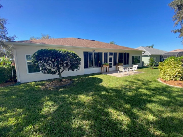 back of property with a patio area and a lawn