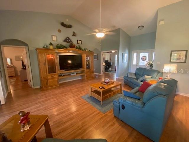 living room with high vaulted ceiling, light hardwood / wood-style floors, and ceiling fan