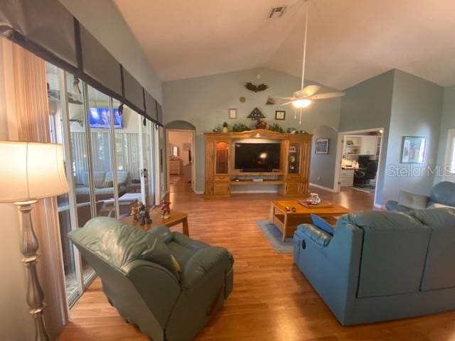 living room featuring ceiling fan, high vaulted ceiling, and light wood-type flooring