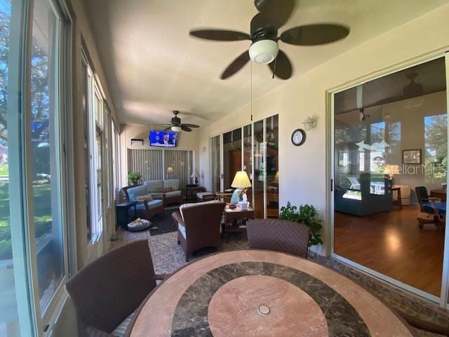 sunroom with a healthy amount of sunlight and ceiling fan