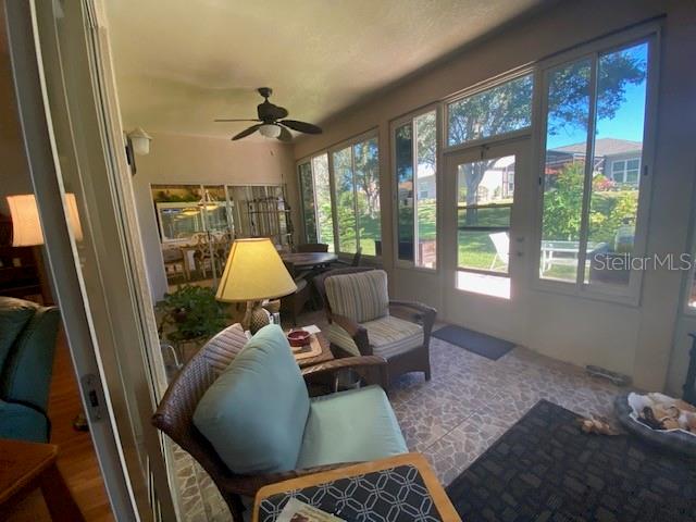 sunroom / solarium with ceiling fan