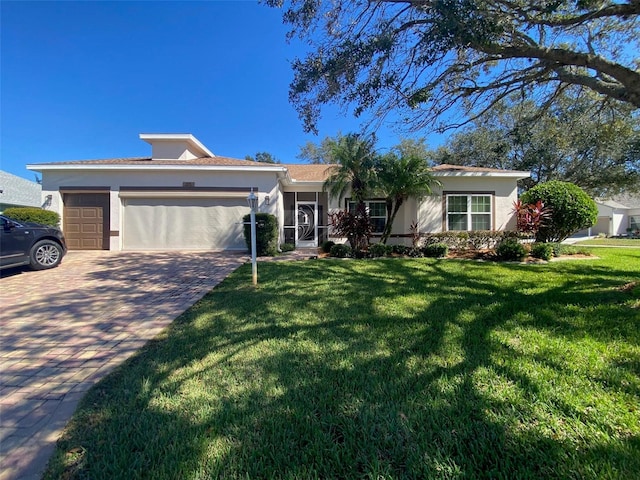 view of front of property featuring a front lawn and a garage