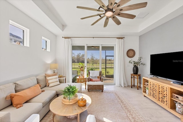 living room with ceiling fan and light wood-type flooring