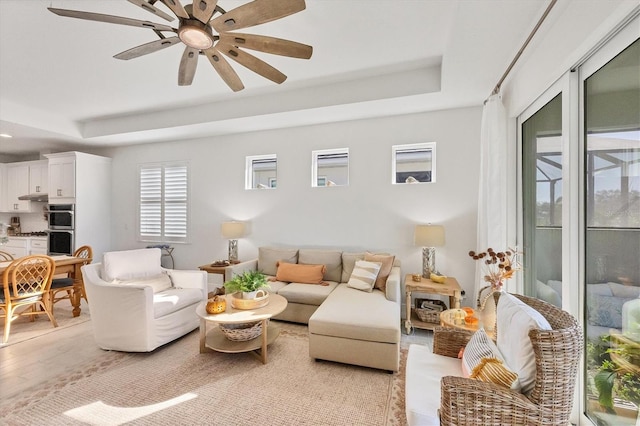 living room featuring light wood-type flooring and ceiling fan