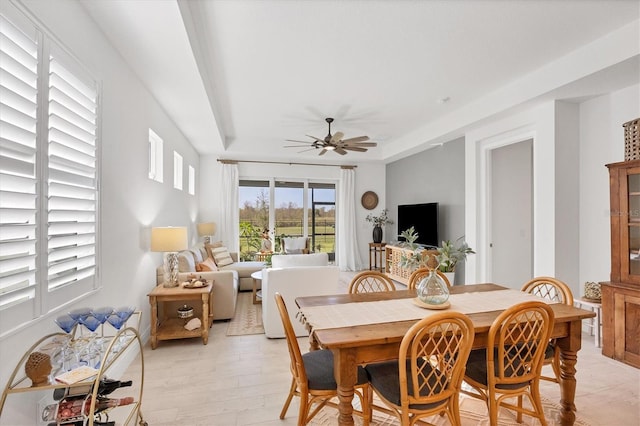 dining space with light wood-type flooring and ceiling fan