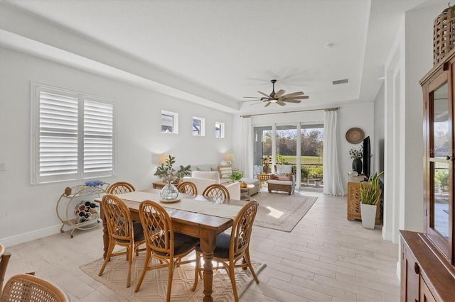 dining area with ceiling fan and light hardwood / wood-style flooring