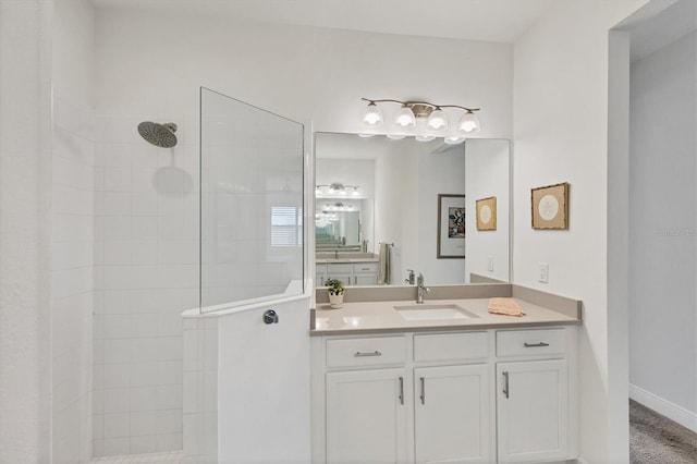 bathroom featuring vanity and tiled shower