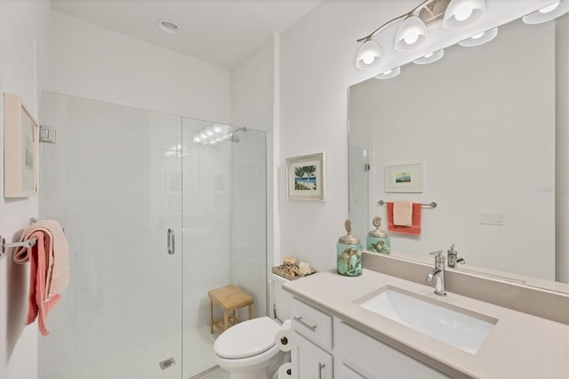 bathroom featuring vanity, toilet, and an enclosed shower