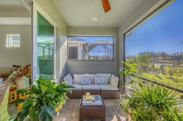 sunroom with ceiling fan