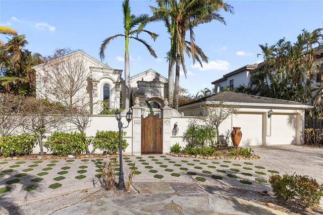 8213 Midnight Pass Rd, Sarasota, FL 34242 - view of front of home with a garage, decorative driveway, stucco siding, a gate, and a fenced front yard