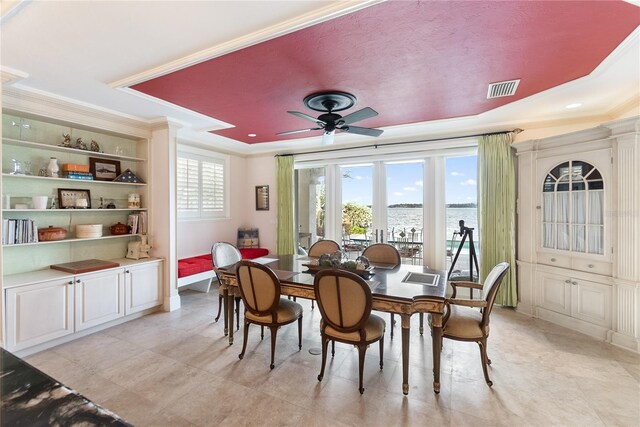 8213 Midnight Pass Rd, Sarasota, FL 34242 - dining space featuring a water view, a ceiling fan, a tray ceiling, and visible vents