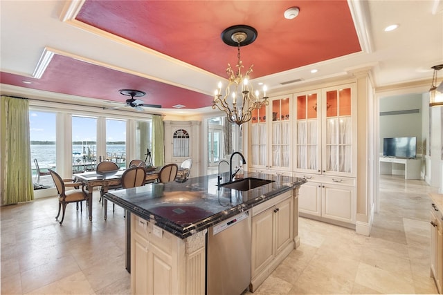 kitchen featuring sink, pendant lighting, stainless steel dishwasher, a water view, and a center island with sink