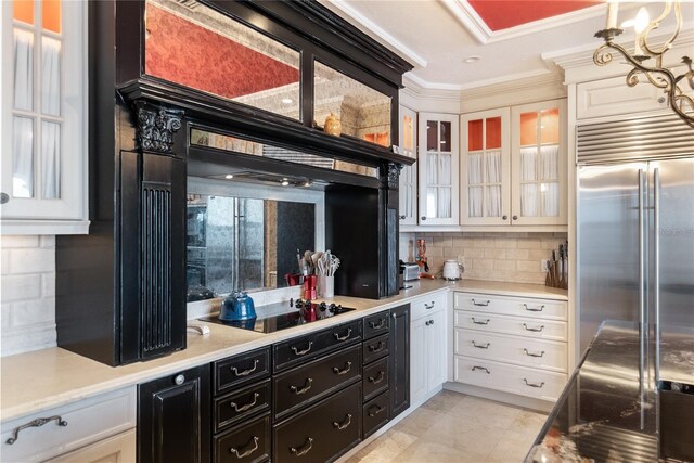 8213 Midnight Pass Rd, Sarasota, FL 34242 - kitchen featuring white cabinets, black electric stovetop, dark cabinetry, built in fridge, and decorative backsplash