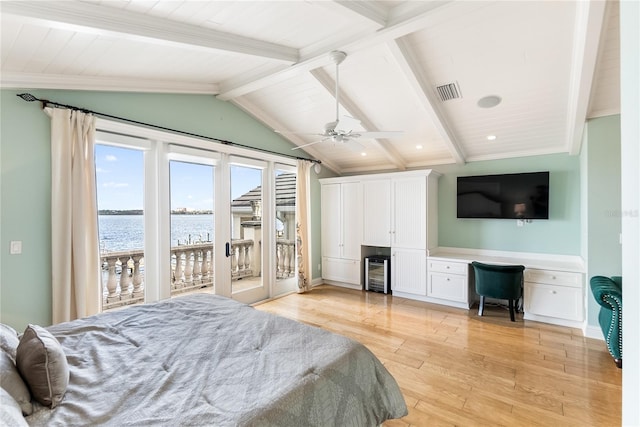 bedroom with built in desk, ceiling fan, access to exterior, light hardwood / wood-style floors, and a water view