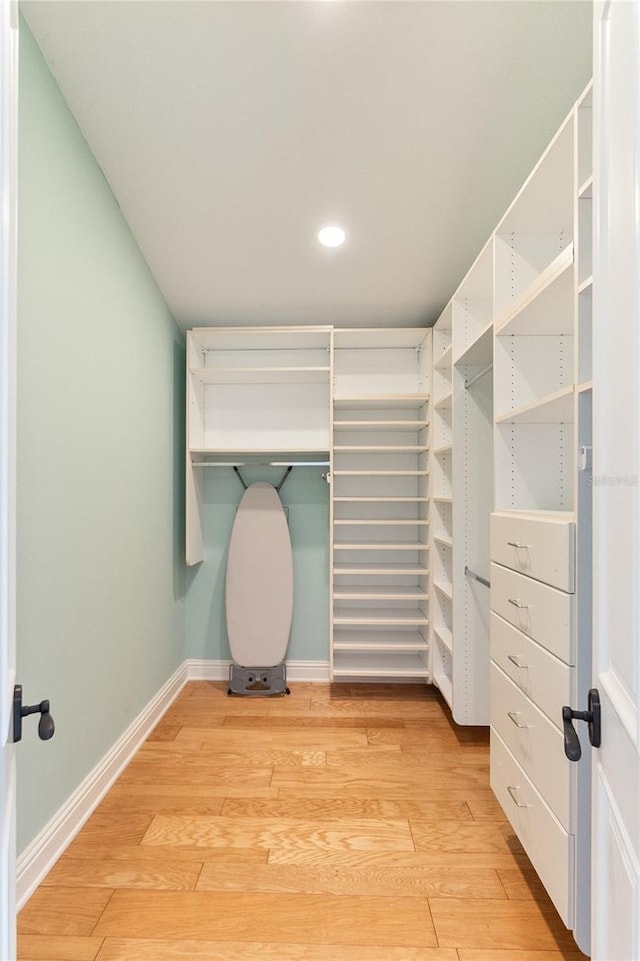 spacious closet featuring light hardwood / wood-style floors