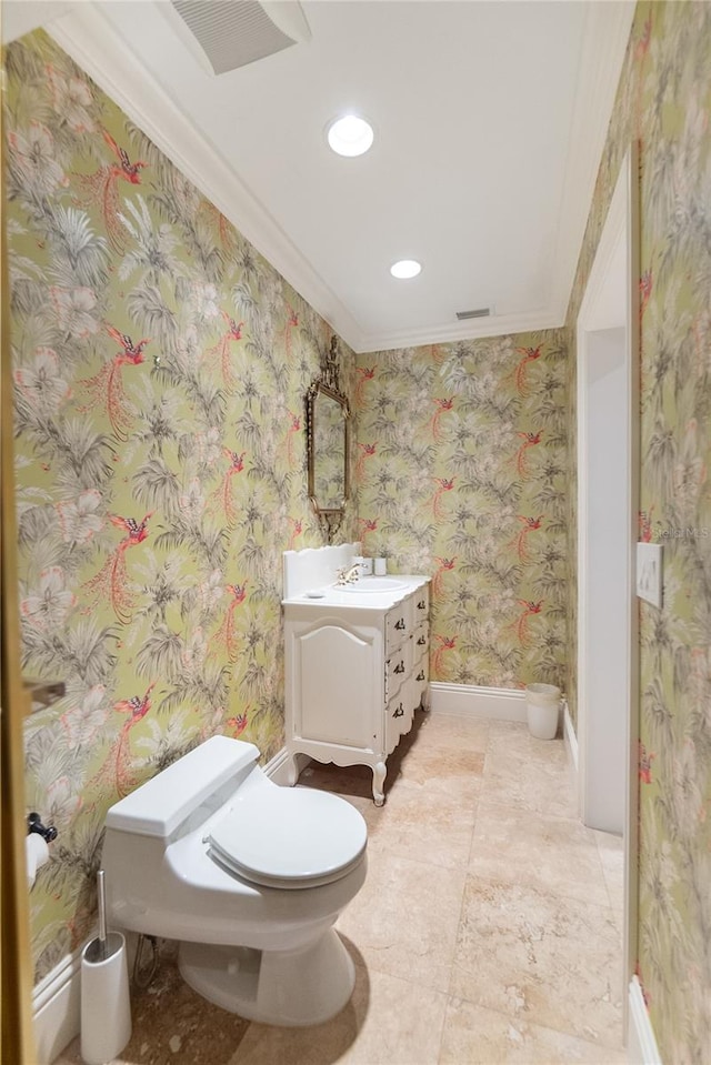 bathroom featuring vanity, crown molding, and toilet