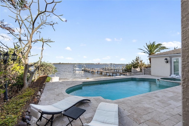 view of pool featuring a patio area, a dock, and a water view