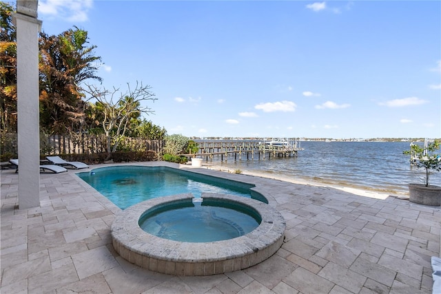 view of swimming pool featuring a patio, an in ground hot tub, and a water view