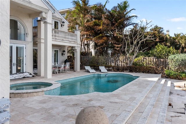 view of pool with an in ground hot tub and a patio area