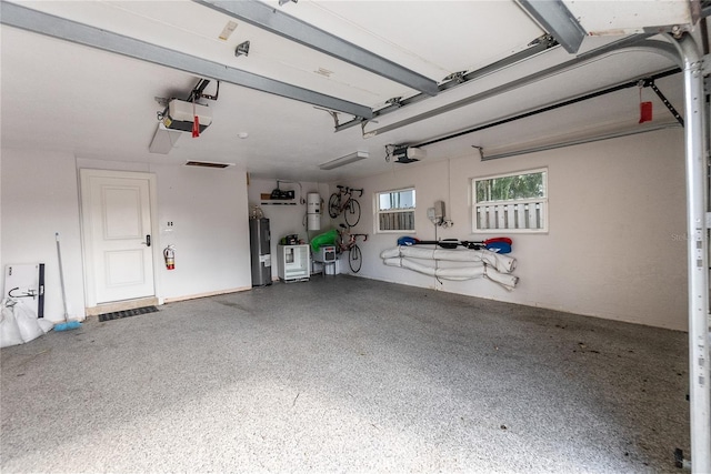 garage featuring a garage door opener, water heater, and secured water heater