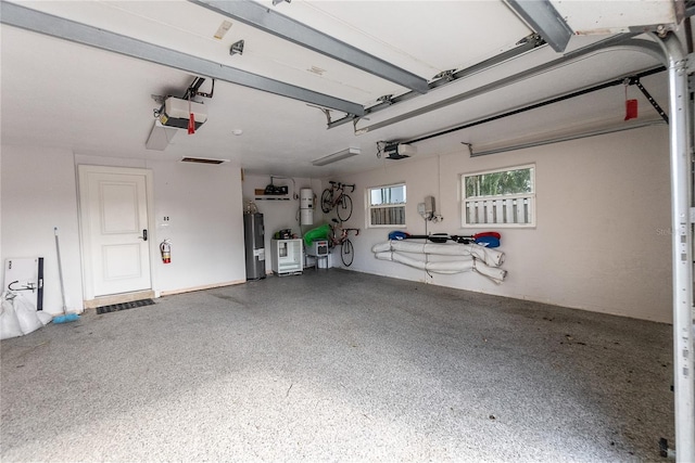 8213 Midnight Pass Rd, Sarasota, FL 34242 - garage with a garage door opener and electric water heater