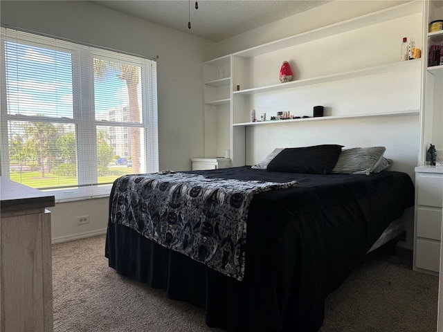 bedroom with light carpet and a textured ceiling