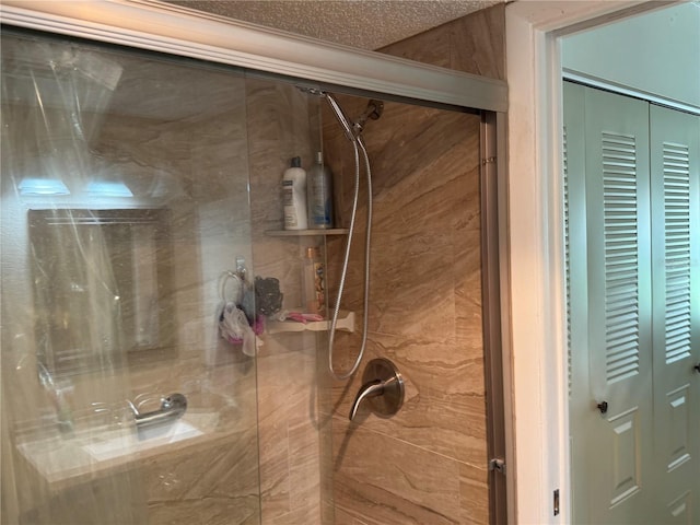 bathroom featuring a shower and a textured ceiling