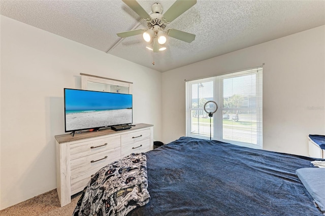 carpeted bedroom with a textured ceiling and ceiling fan