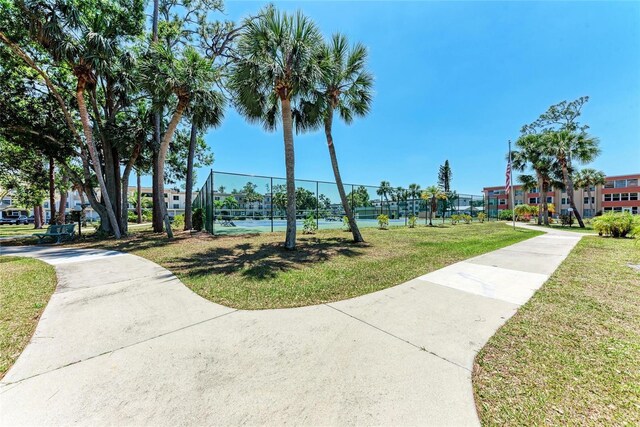 surrounding community featuring fence and a yard