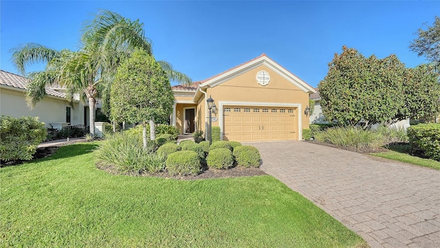 view of front of home featuring a front lawn and a garage