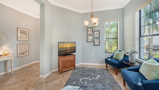 sitting room featuring crown molding and a notable chandelier