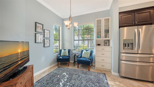 sitting room with crown molding and a chandelier