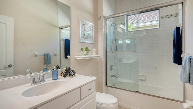 full bathroom featuring vanity, toilet, and enclosed tub / shower combo