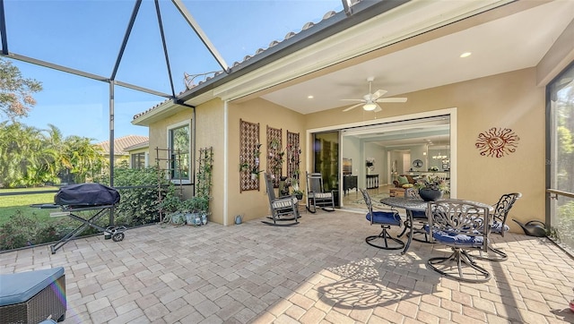 view of patio / terrace with ceiling fan, a grill, and a lanai