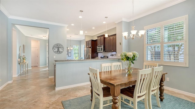 dining area featuring ornamental molding and a chandelier