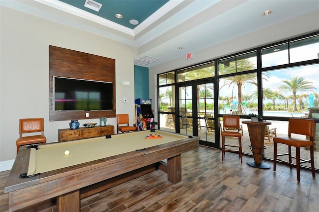 rec room featuring french doors, hardwood / wood-style floors, a tray ceiling, and crown molding