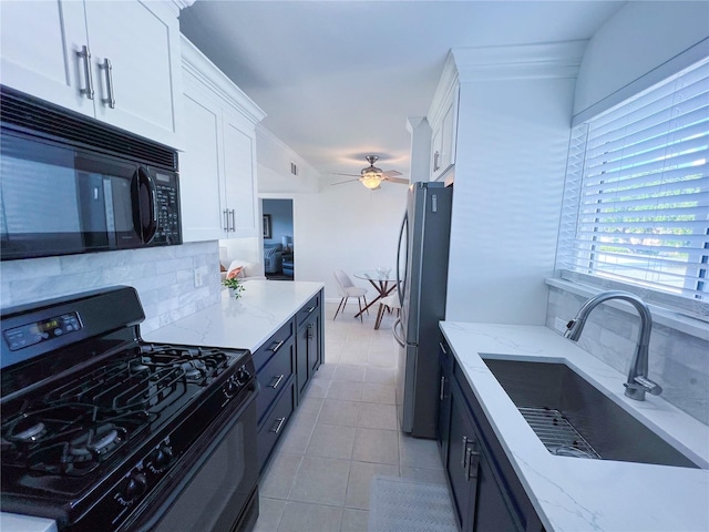 kitchen featuring decorative backsplash, sink, black appliances, white cabinetry, and ceiling fan